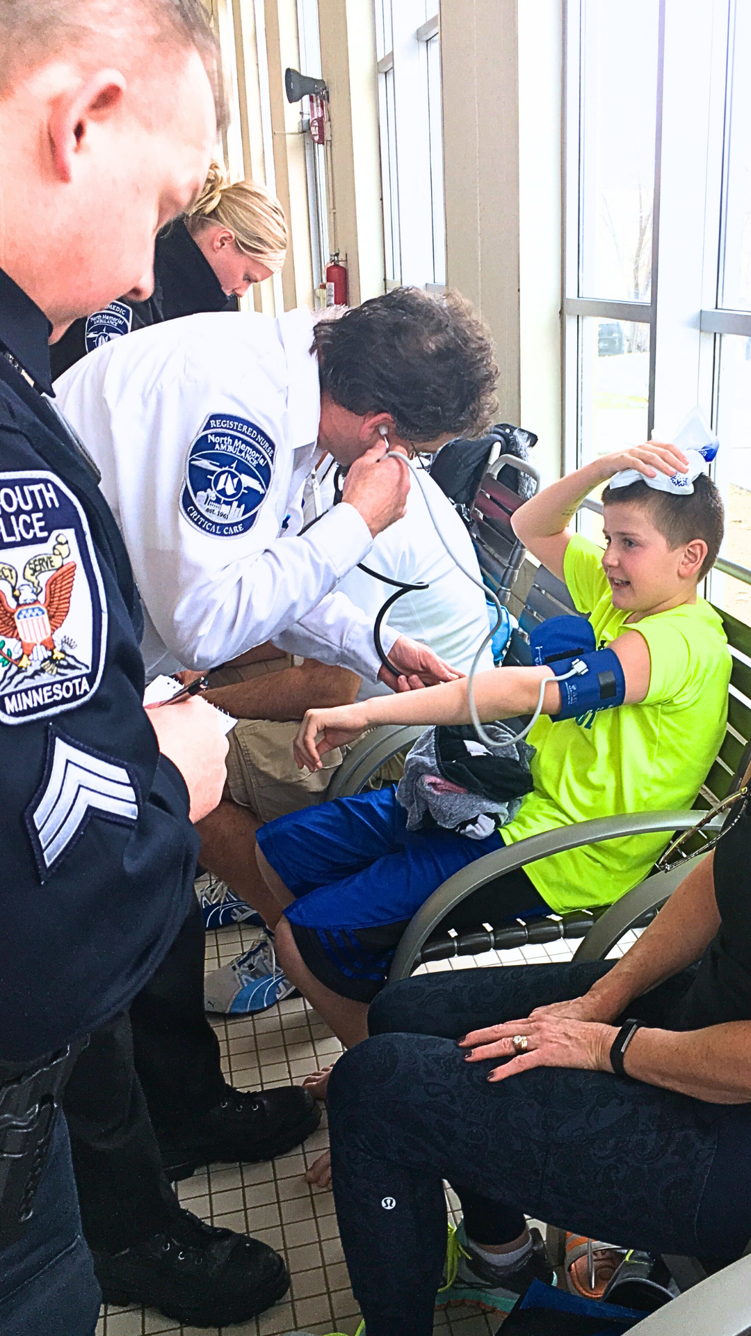 EMS attending to a child with a head injury from the backstroke. 