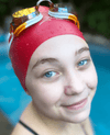 Age group swim caps. Teen female artistic swimmer is wearing the red size medium Hammer Head swim cap in her swimming pool. It is the the best medium swimming cap, is 50% safer than other caps, is up to 10.5% faster than other swimming cap and 100% more durable than other swim caps.