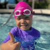 This darling young hispanic girl is learning her four strokes wearing the pink Hammer Head Swim Caps - Safe and Fast Swim Cap for Adults and Youth, 50% Safer and 10.5% Faster than Standard Swim Caps, Durable with 365-Day Guarantee, Approved by Olympians, Parents, Triathletes, and Coaches. Hammerhead swim caps is a waterproof swim cap, qualifies for custom swim caps with three size options and delivers moms protective swim caps.